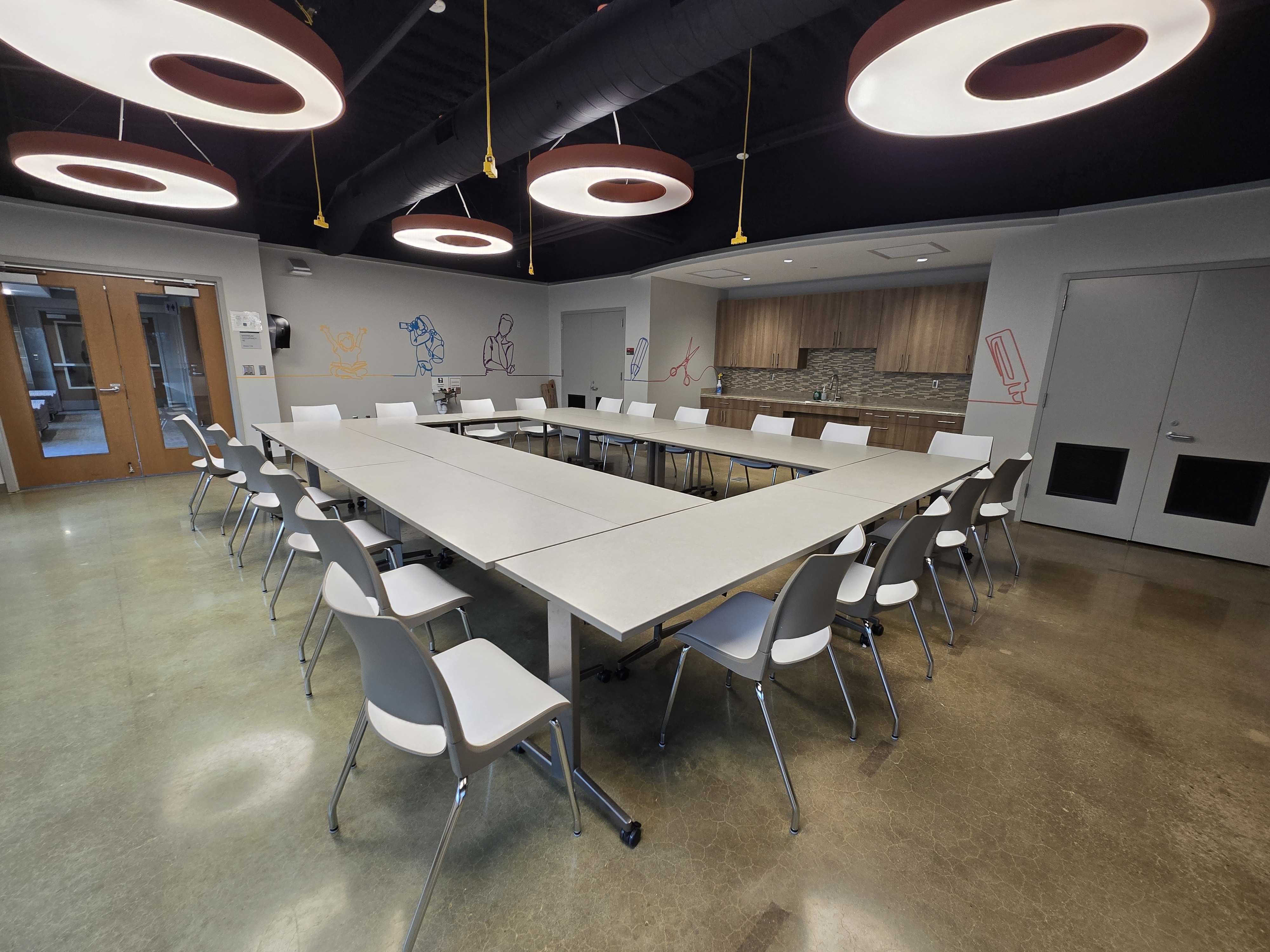 Classroom where tables and chairs are set up in a hollow-squared layout.