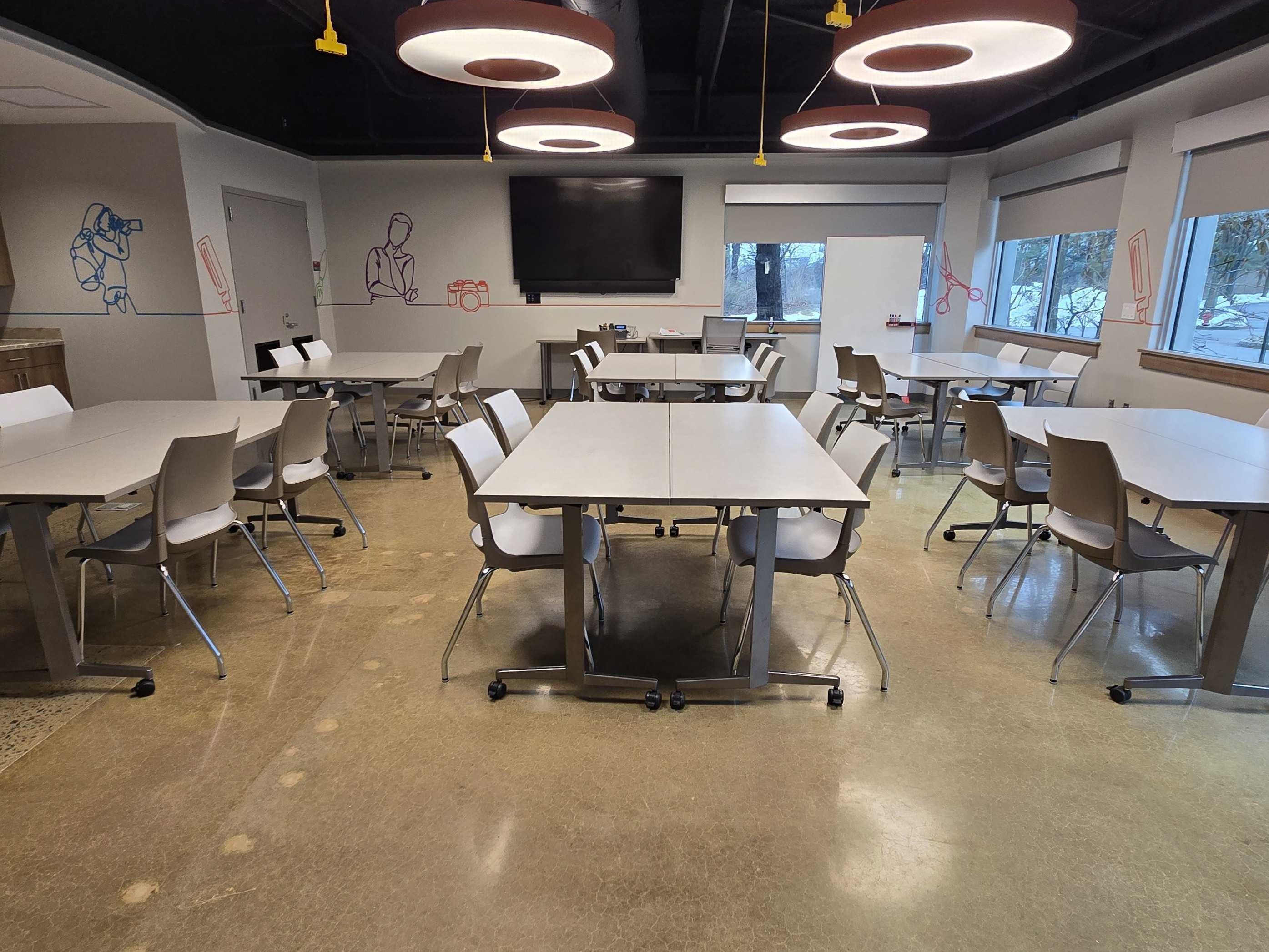 Classroom in groups of tables and chairs.