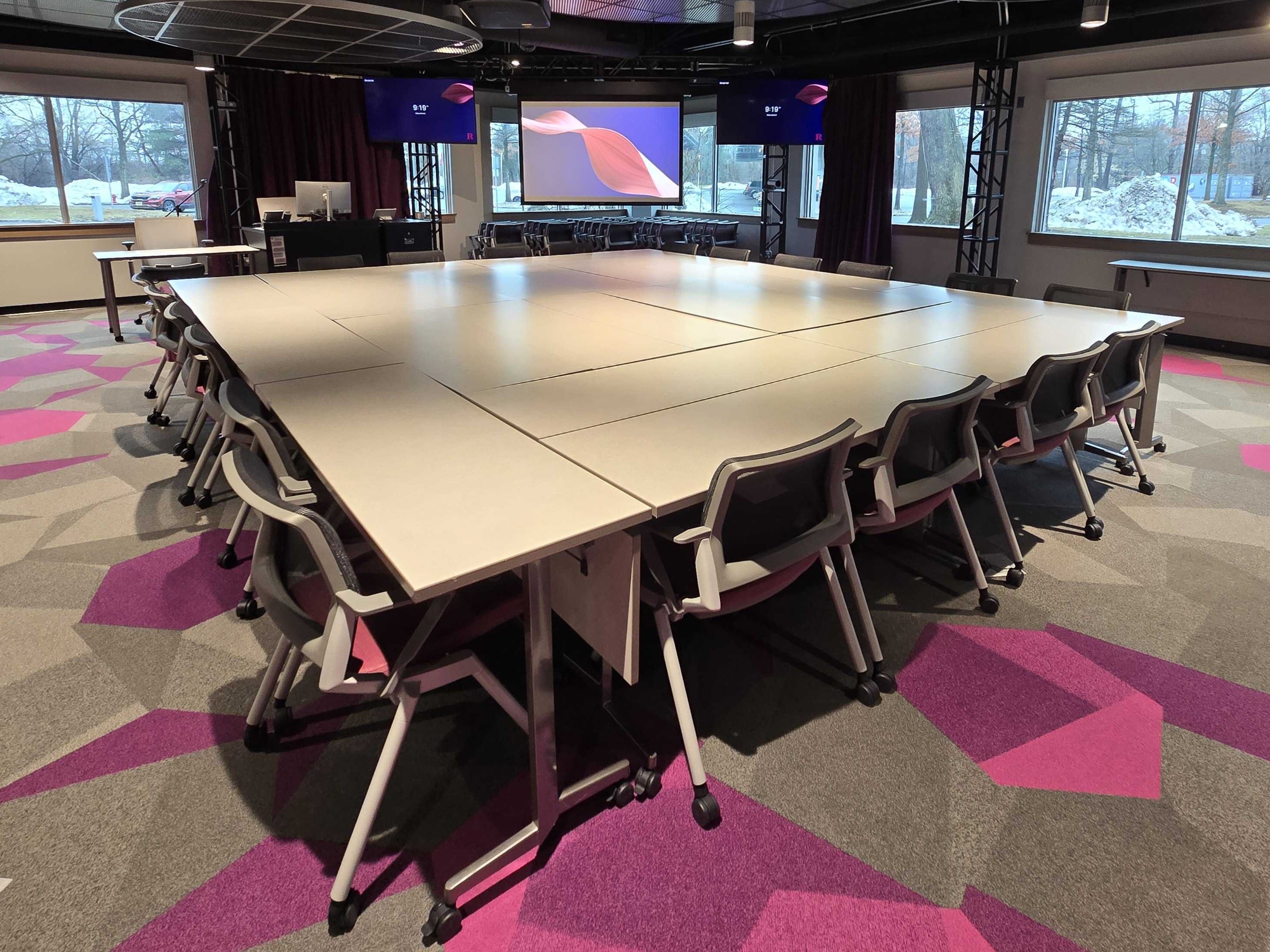 Tables arranged in a large conference table layout.