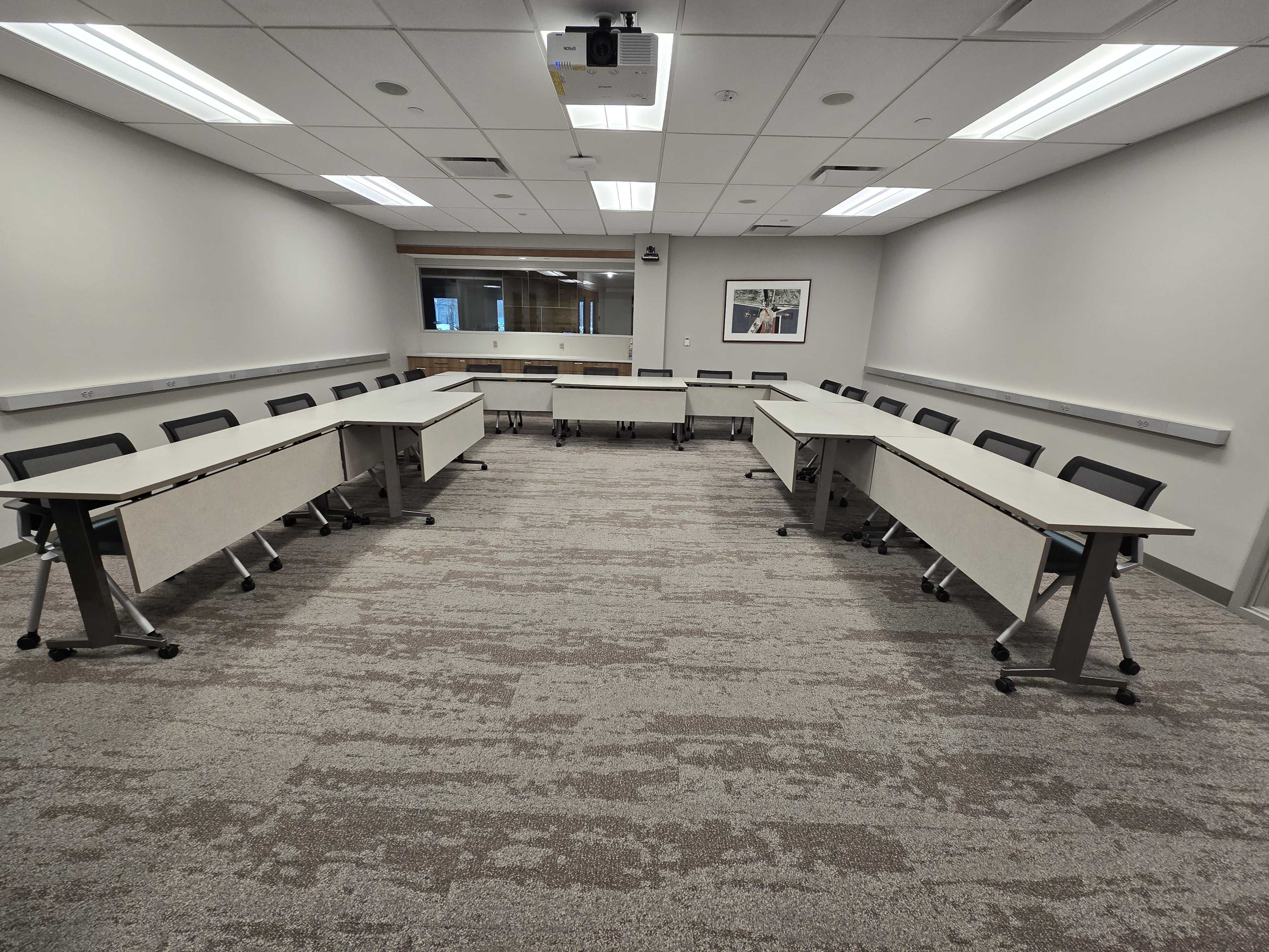 Tables and chairs arranged in a u-shape layout.